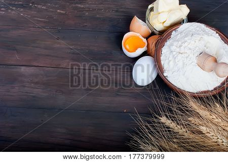 Bowl With Flour Eggs Ears Of Wheat And Butter On Vintage Wooden Board Food And Drink Concept