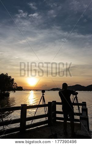silhouette photographer Nature and sunset at songkhla lake thailand