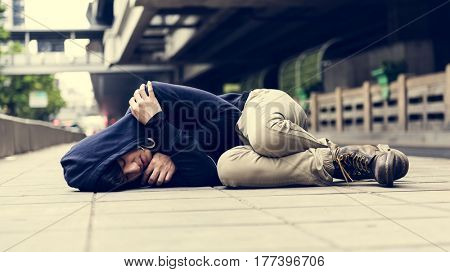 Young man homeless sleep on the street