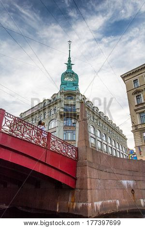 ST. PETERSBURG RUSSIA - JULY 14 2016: View of the red bridge and the house 