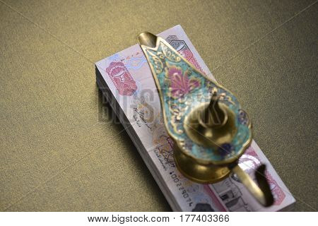 Top view of an Aladdin lamp placed over currency notes. Cash rewards - A conceptual image.