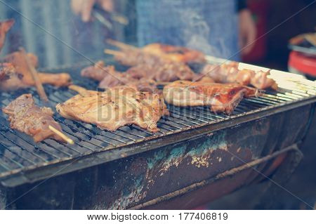 Barbecue chicken - traditional street food in Bangkok Thailand Selective focus matte filter