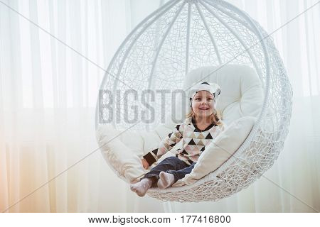 Child In Soft Warm Pajama Playing In Bed