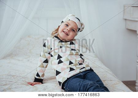 Child In Soft Warm Pajama Playing In Bed