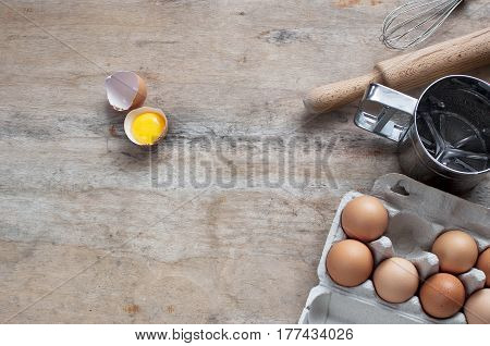 Kitchen objects Metal Utensils Spoon Eggs on a wooden table. Cooking Baking Eggs Grocery Top view