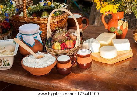 Dairy products on wooden table. Cheese and milk on the table in an earthenware dish. Concept of rural organic food. Food background. concept of small business.