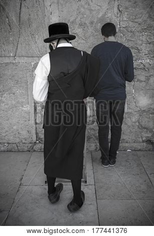 JERUSALEM, ISRAEL - MARCH 06, 2017: Hasidim (orthodox Jews) pray at the Western Wall in the old city