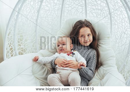 Child in soft warm pajama playing in bed. In good light studio