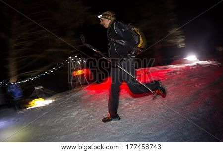 ALMATY, KAZAKHSTAN - 18 FEBRUARY 2017: Night competitions in the foothills of the city of Almaty, in the Trailrunning and Skyship discipline, which is called TunRun winter edition. Man running in the mountains at night.