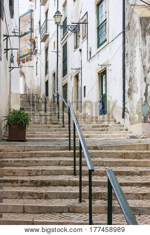 Narrow cobblestone stairs in urban city streets of Lisbon Portugal