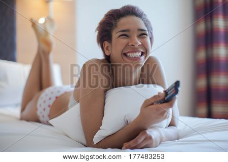 Young Woman Watching Tv In The Room. Young Beautiful Woman In Bed. Young Black Woman Seat In Bed.