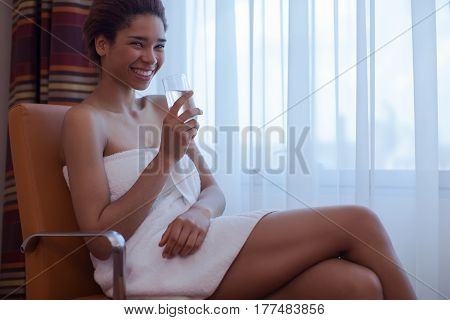 Young Beautiful Woman Sitting In The Chair Next To The Window After A Shower.