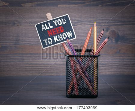All You Need To Know. A small blackboard chalk and colored pencil on wood background.