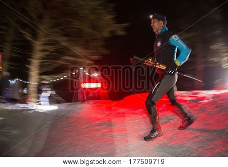 ALMATY, KAZAKHSTAN - 18 FEBRUARY 2017: Night competitions in the foothills of the city of Almaty, in the Trailrunning and Skyship discipline, which is called TunRun winter edition. Man running in the mountains at night.