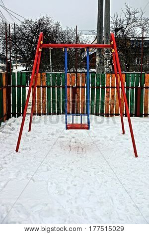 Iron swing at the playground in the winter