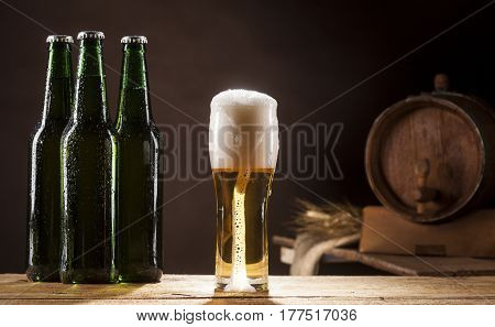 Beer Barrel With Three Bottles And Mug On Brown Background