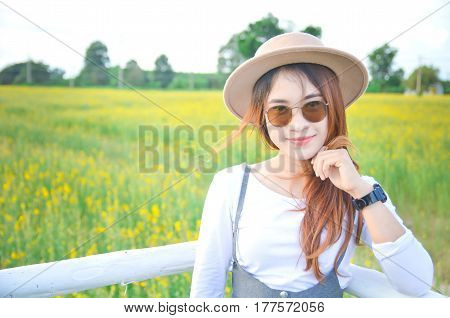woman stands happily in the flower garden. sunhemp