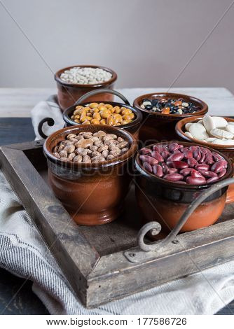 Assortment of beans on black wooden background. Soybean red kidney bean black beanwhite bean red bean and brown pinto beans