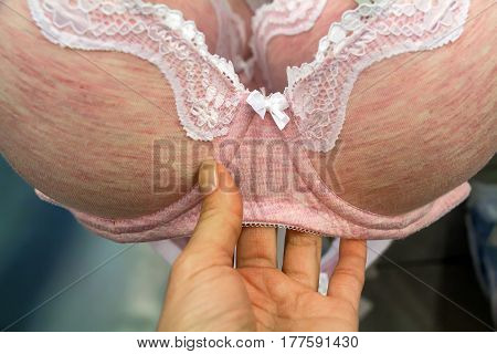 Close up of woman hand choosing lingerie in supermarket