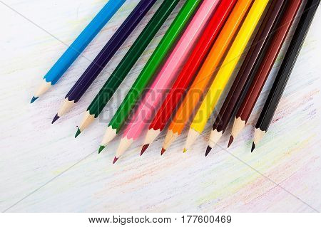 A colored pencils on a white paper