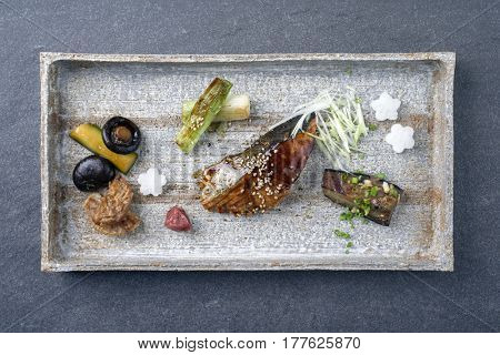 Traditional Japanese dish with Fish Teriyaki and Vegetable as close-up on a tray