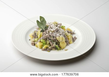 Single Pasta dish portion pizzoccheri isolated on white