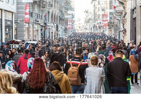Hundreds of diverse People walking along Istiklal street most popular shopping and entertainment place during weekends. Istiklal Caddesi, Istanbul, Turkey, November 19, 2016