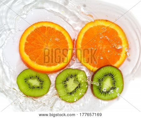orange and kiwi in water white . 