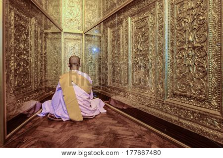 Myanmar nun sitting for meditation in Shwenyaungbin myanmar temple yangon myanmar