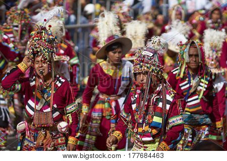 ORURO, BOLIVIA - FEBRUARY 25, 2017: Tinkus dancers in colourful costumes performing at the annual Oruro Carnival. The event is designated by UNESCO as being Intangible Cultural Heritage of Humanity.