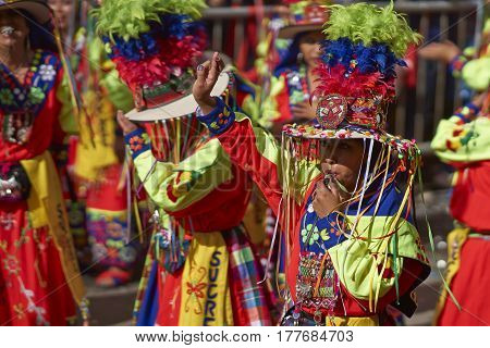 ORURO, BOLIVIA - FEBRUARY 25, 2017: Tinkus dancers in colourful costumes performing at the annual Oruro Carnival. The event is designated by UNESCO as being Intangible Cultural Heritage of Humanity.