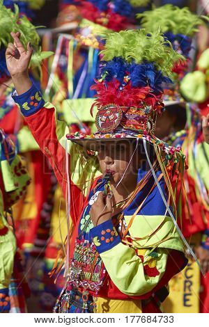 ORURO, BOLIVIA - FEBRUARY 25, 2017: Tinkus dancer in colourful costume performing at the annual Oruro Carnival. The event is designated by UNESCO as being Intangible Cultural Heritage of Humanity.