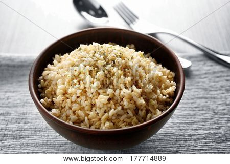 Bowl full of brown rice on napkin