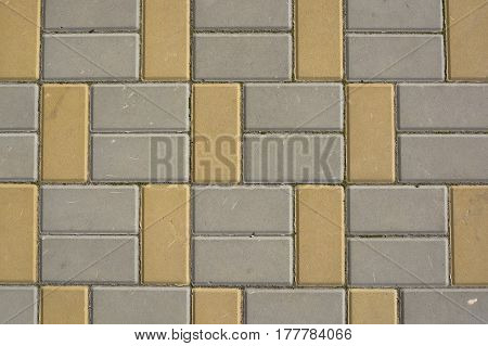 Texture of road surface with grey and yellow pave stones