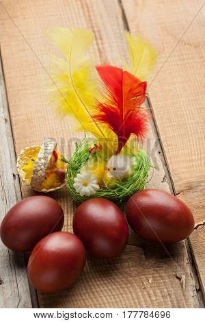 Red Easter Eggs On Old Wood Table With Feather And Chicken