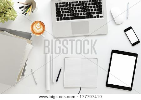 Office desk wood table with labtop computerblank magazine smart phone and coffee cup Top view with copy space3D rendering