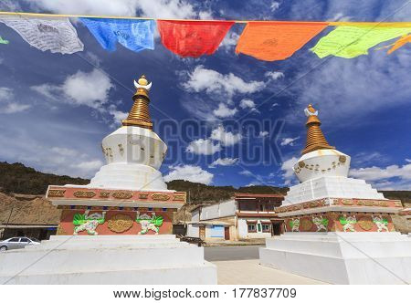 Prayer flags and stupas at the gate of Deqing city Yunnan China