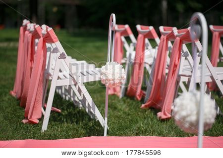 Wedding registration beautiful in nature. White chairs for visiting registration. Pink tent with white flowers for the exit registration. White and pink peonies with roses. Wedding details