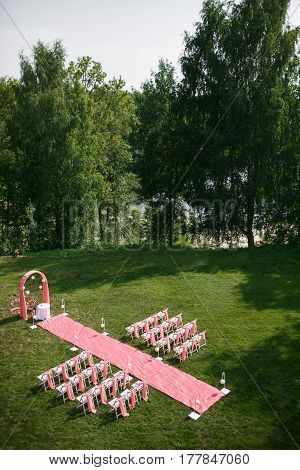 Wedding registration beautiful in nature. White chairs for visiting registration. Pink tent with white flowers for the exit registration. White and pink peonies with roses. Wedding details