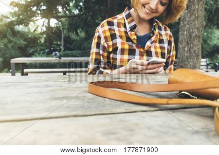 Hipster person holding in hands digital mobile smart phone young girl smile reading on gadget on background nature park landscape mock up technology blur female hands tourist using connect sun flare