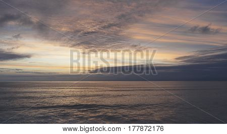 Clouds sky and sunlight gold sunset on horizon ocean. Background seascape dramatic atmosphere rays sunrise. Relax view waves water sea mock up nature evening concept perspective sunrise
