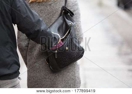 Close-up Of A Person Stealing Purse From Handbag