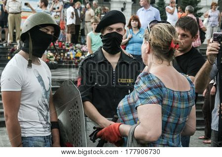 KIEV UKRAINE - AUGUST 9 2014: Pravy Sektor Military volunteer observing the removal of the last barricades on Maidan Square (independence Square) in Kiev