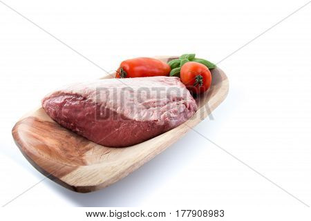 Full Piece Of Raw Cow Beef (picanha), Tomatoes And Basil On A Wood Rectangular Bow With White Backgr