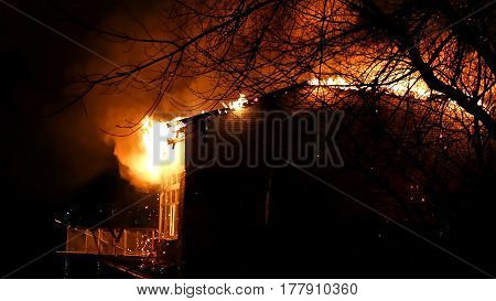 House building on fire at night. Blaze Inferno conflagration and combustion.