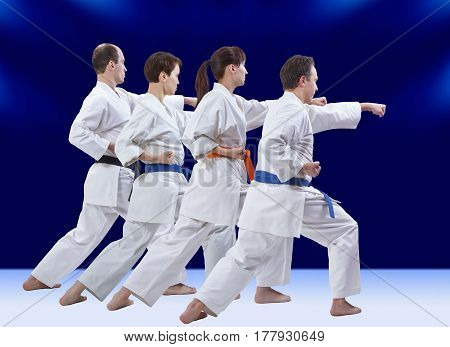 On a dark blue background the athletes are beating punch arm