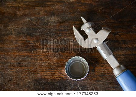 bottle opener with Bottle Cap on wooden table background
