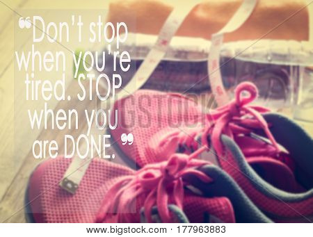 Inspirational quote on sneakers towel water and tape measure background. 