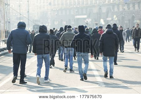 Crowd of people walking on busy city street