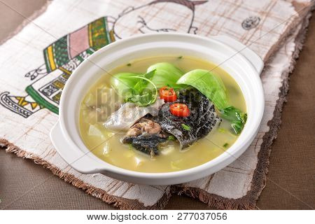 Turtle Soup Made With Rice In A White Pot